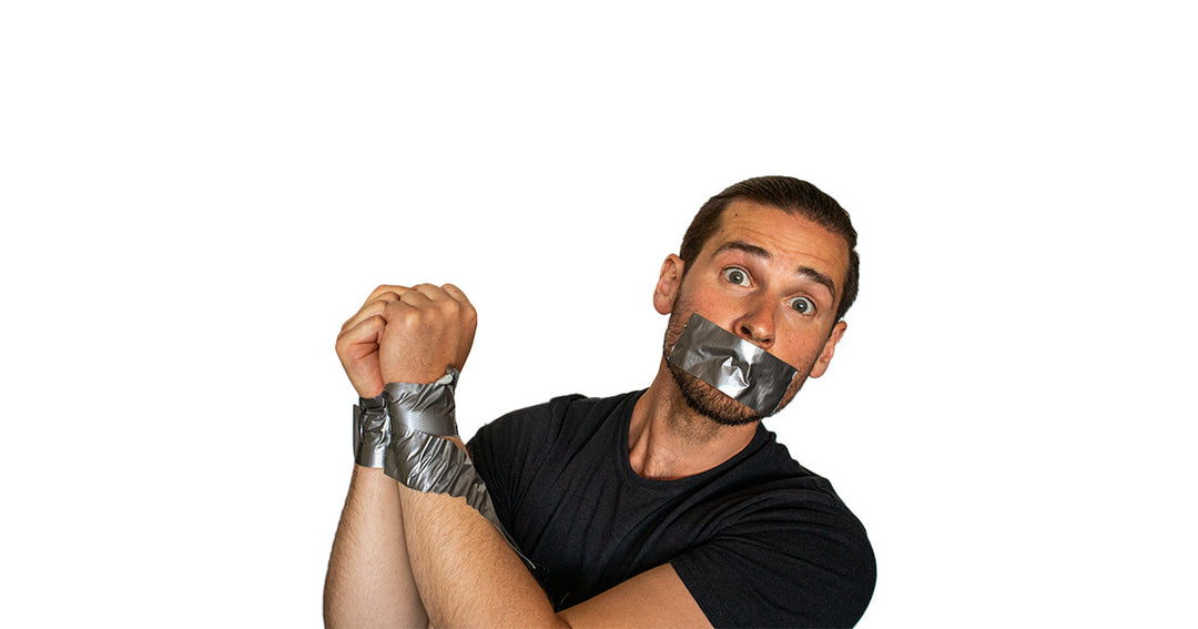 Person restrained with duct tape over the mouth and wrists illustrating an article about escaping illegal restraints.