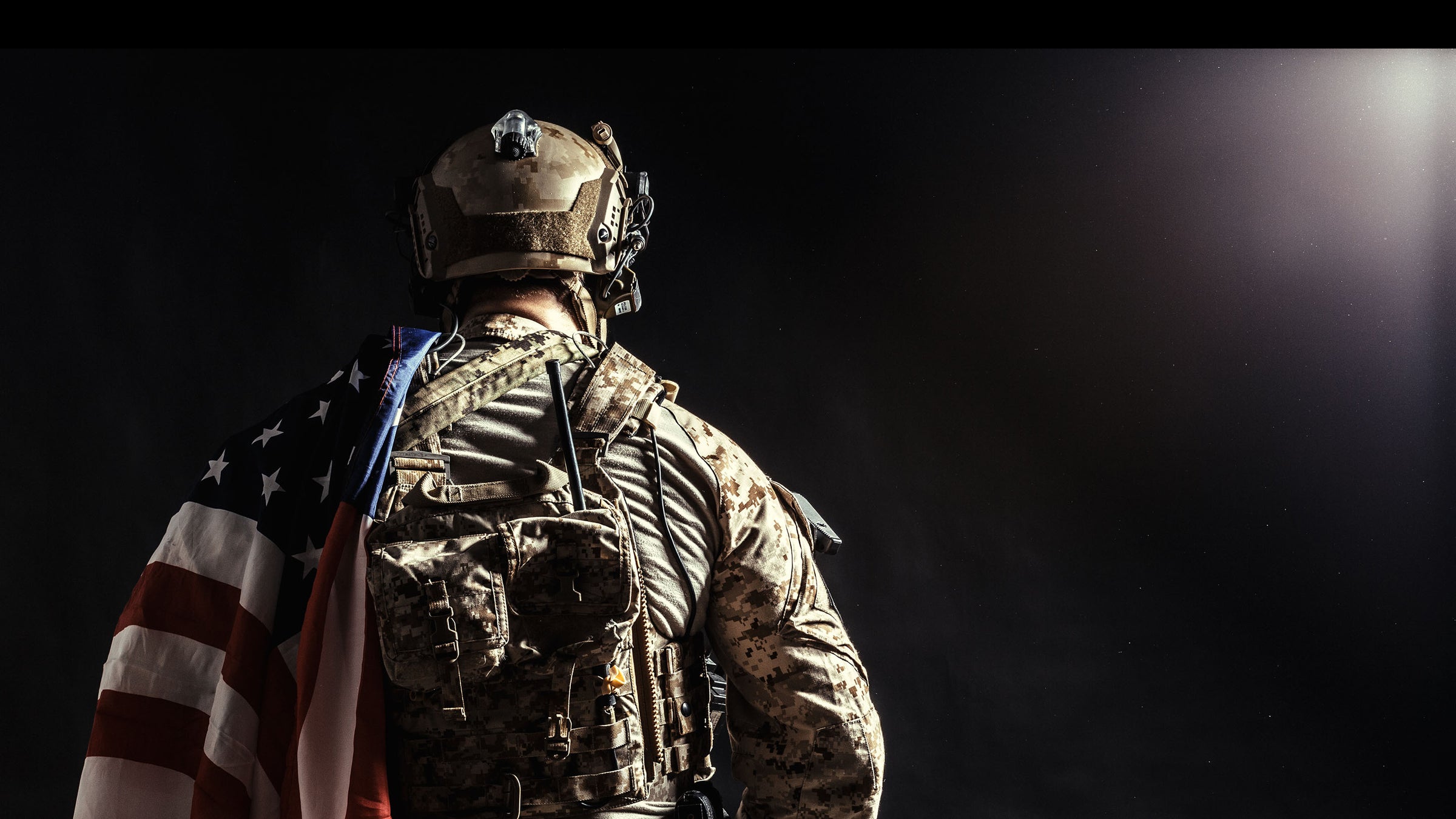 Soldier carrying American flag on Sierra Whiskey Co About page hero image